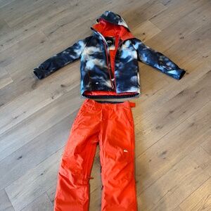 Quiksilver. Blue and white jacket with matching Orange pants. Ski/snowboard